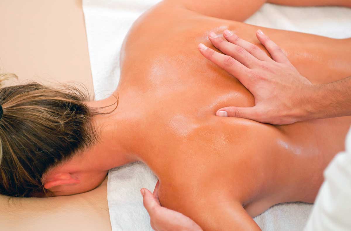 Qualified remedial massage therapist treating a client at Wellness Centre Wollongong
